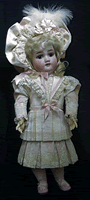 Antique doll re costumed in silk,batiste lace